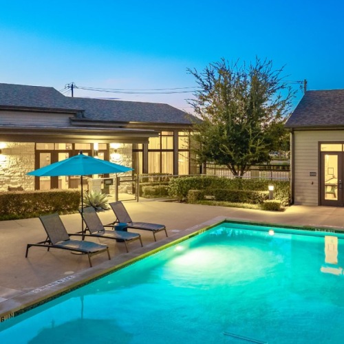 pool with lounge chairs and umbrella