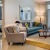 Living room with couch, chair and double patio doors.